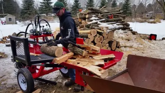 can a log splitter get wet - man log splitting in winter season