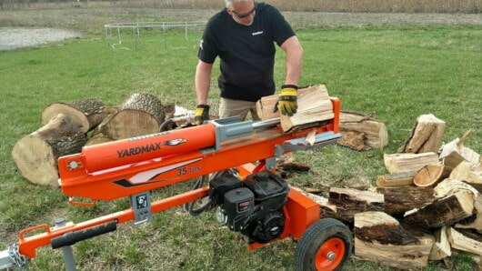 how much does it cost to rent a log splitter - man using rented log splitter