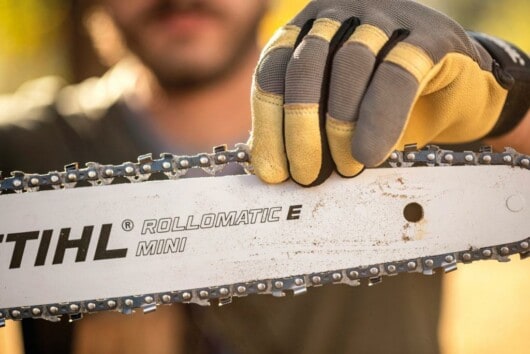 How Often Should I Sharpen My Chainsaw 5 man putting chainsaw chain in bar
