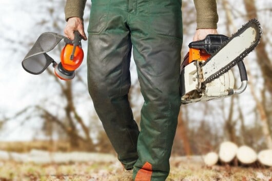 man wearing safety chainsaw gears