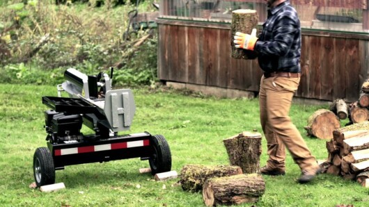 where can i rent a log splitter - man using rented log splitter